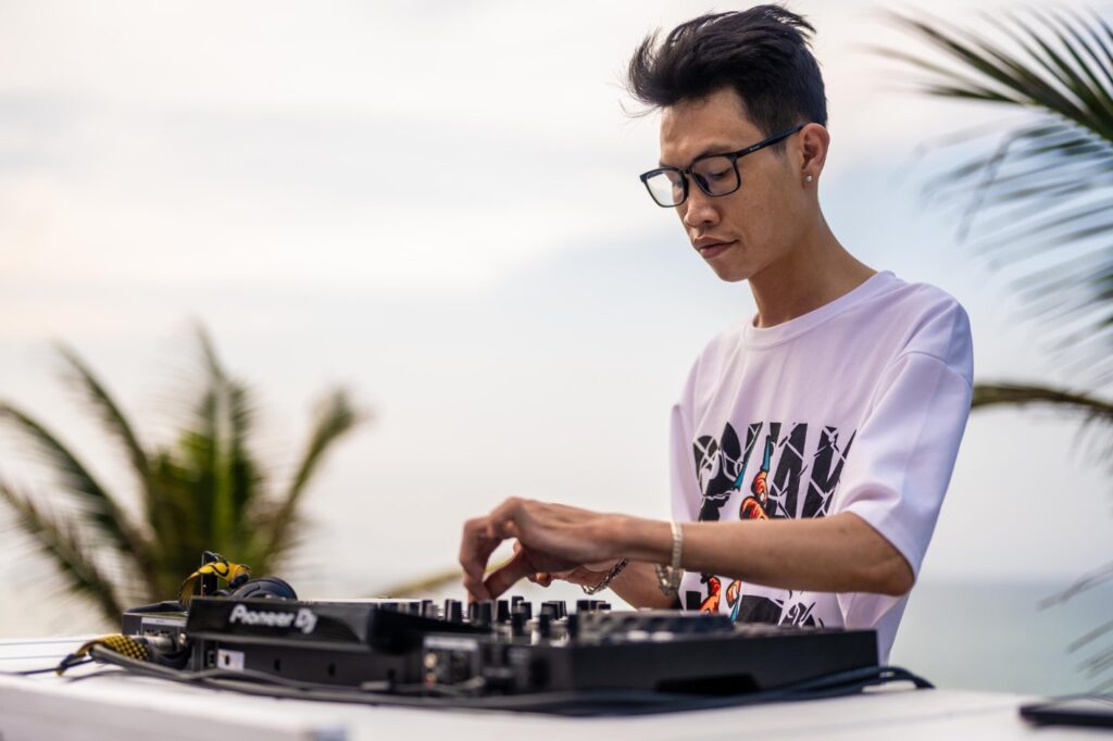DJ Hee, a top local music producer and Shore Club's resident DJ, spinning relaxed afternoon beats with the Vietnam Sea as a scenic backdrop at Shore Club’s beachfront DJ booth, the number one destination on An Bang Beach.