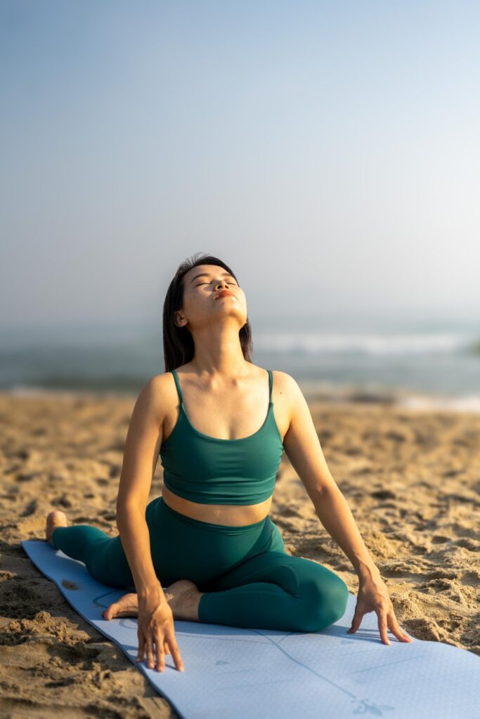 Students stretching before the start of sunrise yoga on An Bang Beach at Shore Club, Hoi An, Vietnam.